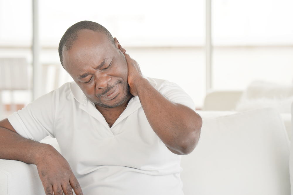 man experiencing chronic neck pain