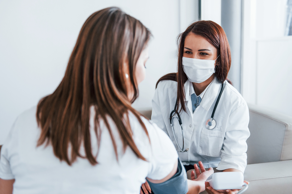 female patient getting blood pressure taken from female provider