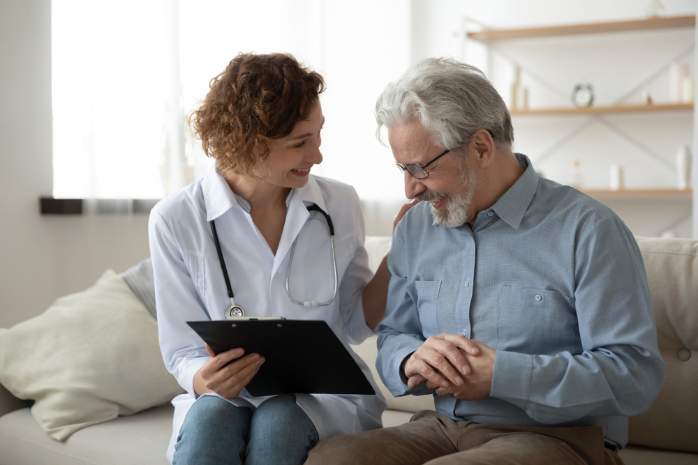 Man discussing symptoms with pain management doctor.